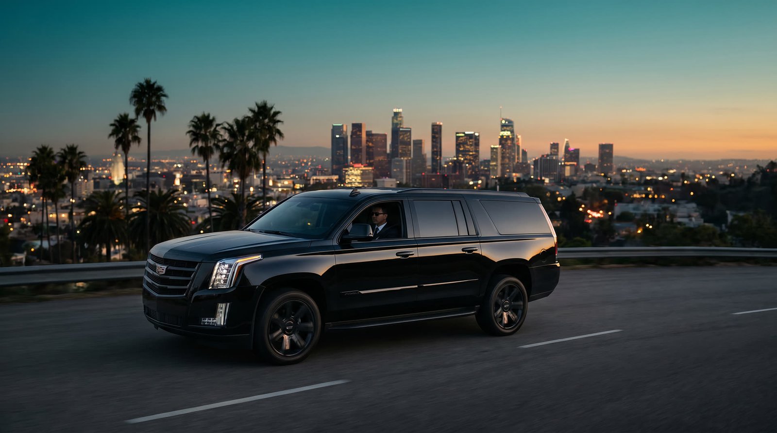 Luxury SUV cruising Mulholland with downtown LA skyline